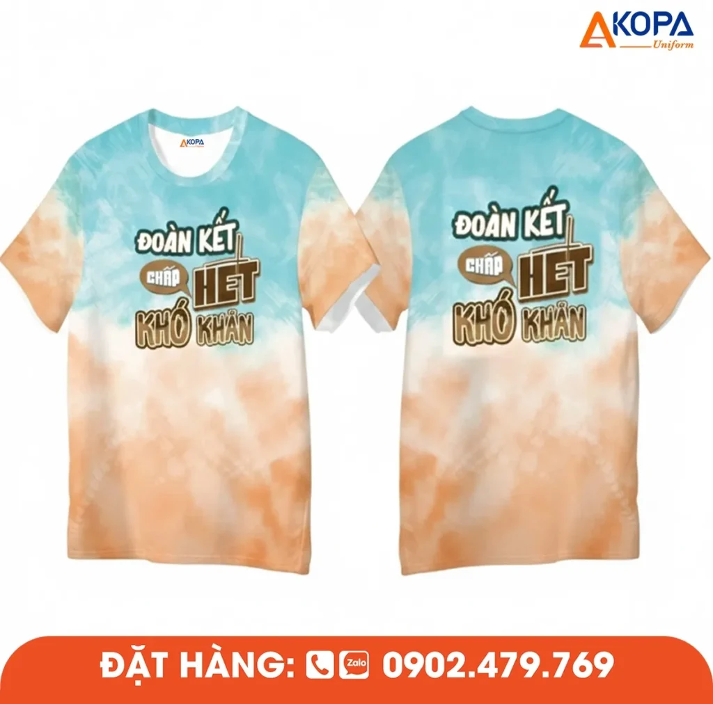 Áo phông đồng phục nhóm thiết kế màu loang xanh cam độc đáo cùng slogan “Đoàn kết chấp hết khó khăn”, phù hợp cho du lịch, teambuilding và sự kiện tập thể.
