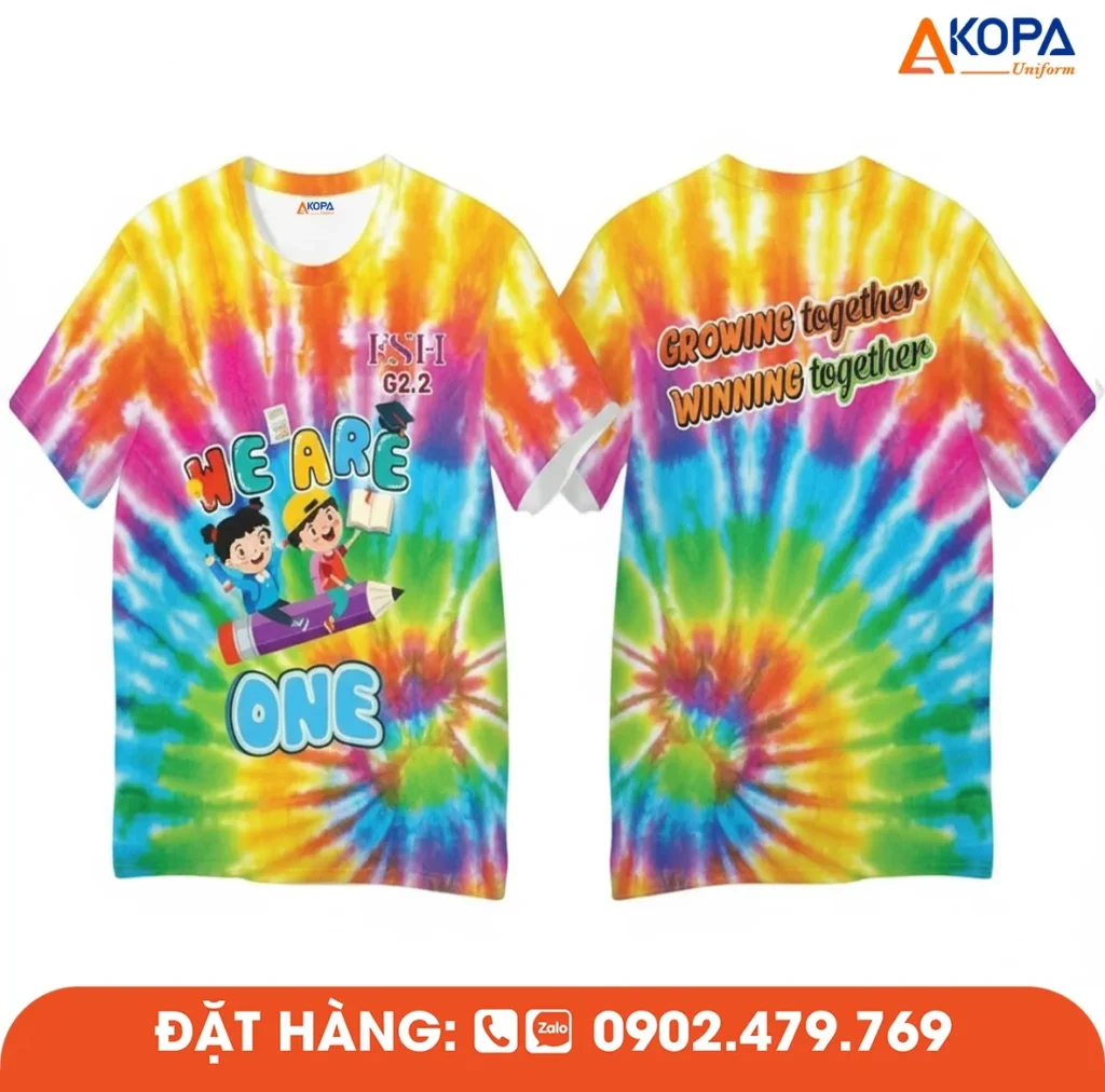 Áo phông đồng phục nhóm thiết kế tie-dye nhiều màu cùng slogan “We Are One”, phù hợp cho du lịch, teambuilding, sự kiện và các hoạt động gắn kết tập thể.