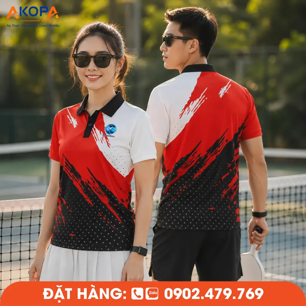 Mẫu áo đồng phục Pickleball có cổ phối đỏ, trắng và đen với họa tiết cọ sơn cá tính. Thiết kế nổi bật cả mặt trước và mặt sau, phù hợp cho đội thi đấu, câu lạc bộ và giải Pickleball.