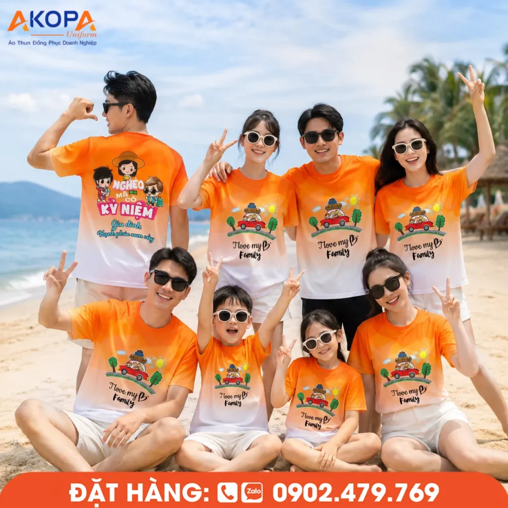 Áo đồng phục team building tông cam phối trắng nổi bật, thiết kế dành cho gia đình và nhóm du lịch, mang phong cách trẻ trung, năng động, phù hợp cho các chuyến nghỉ dưỡng và vui chơi trên biển.
